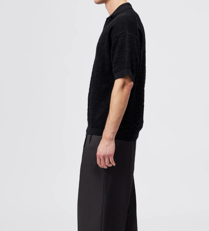 Black Drykorn LAURENZZO oversized cotton knit polo for men with short sleeves, wide placket, and soft textured knit for modern casual style.