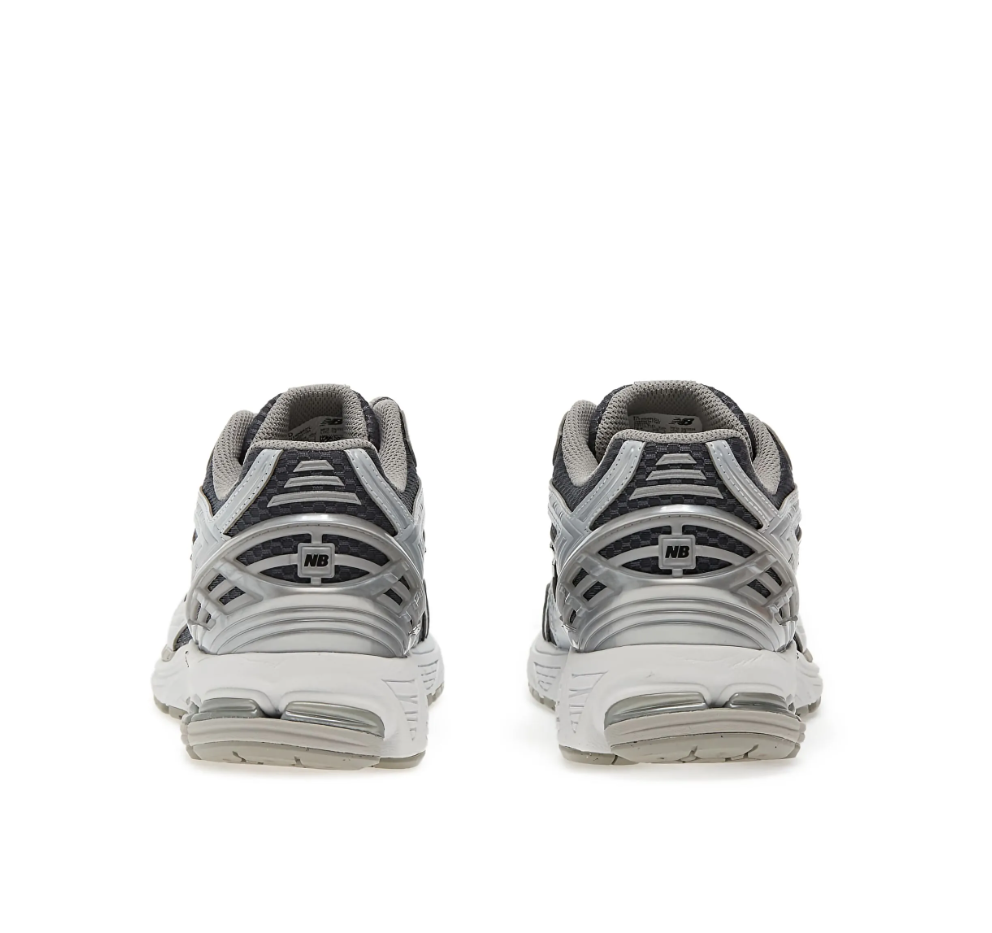 New Balance 1906R sneakers for men in grey and silver with mesh upper and cushioned sole.