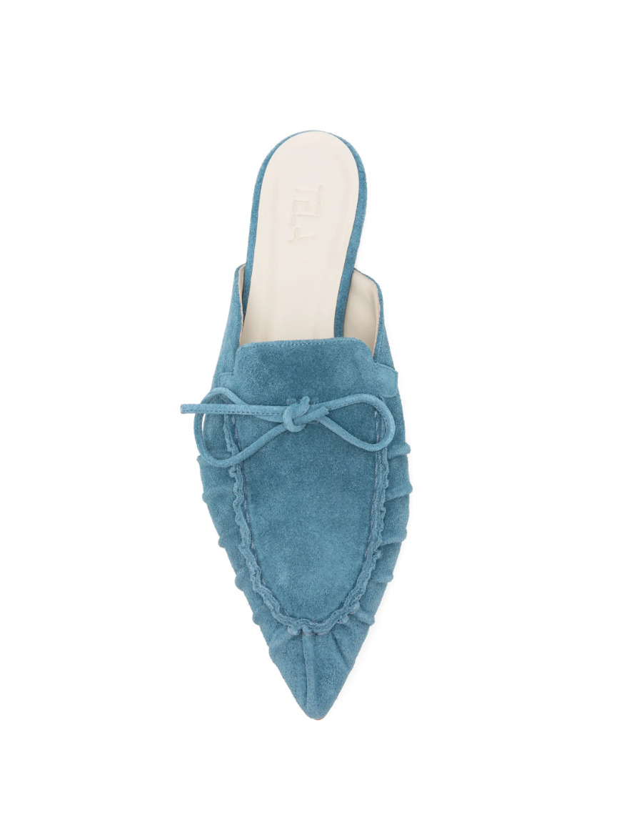 Blue suede tie-detail flat mules by Tela, made in Italy with slip-on design and pointed toe for chic everyday style.