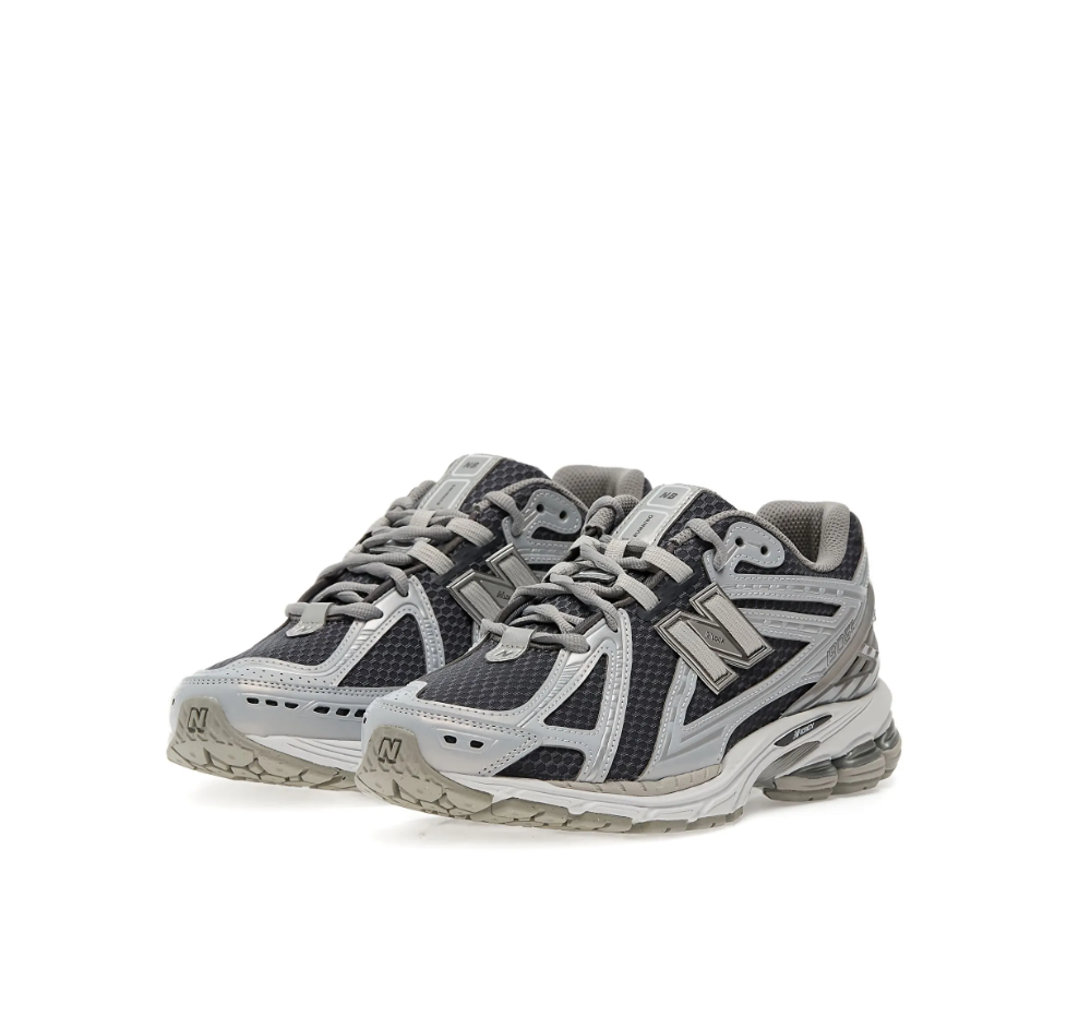 New Balance 1906R sneakers for men in grey and silver with mesh upper and cushioned sole.