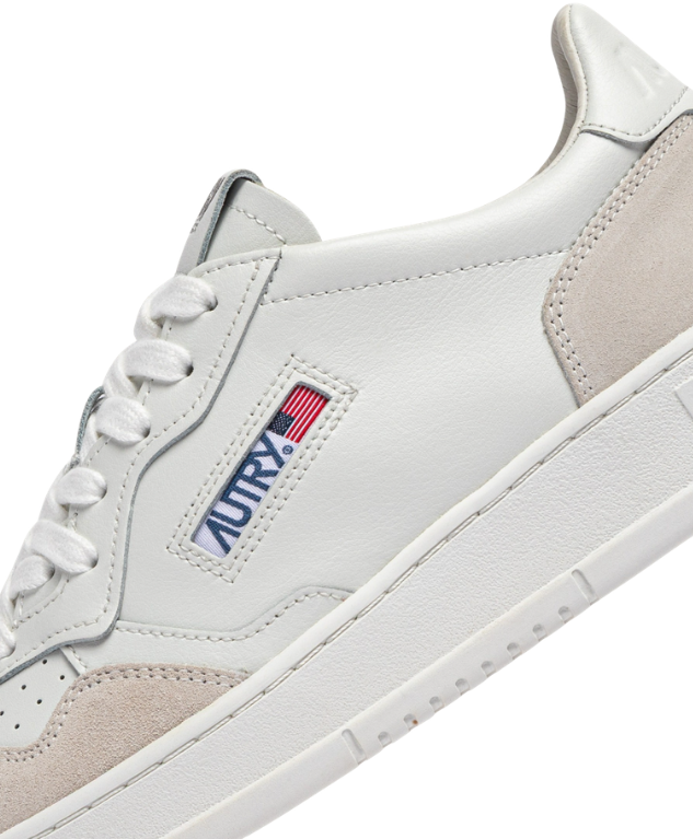 Autry Medalist sneakers in white with suede overlays, perforated toe, and rubber sole.