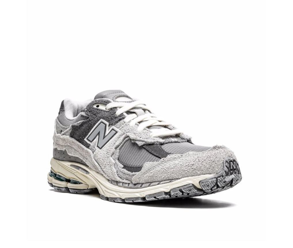 New Balance 2002R Protection Pack sneakers in Rain Cloud with distressed suede overlays and cushioned sole.