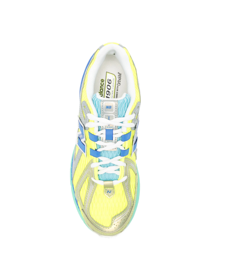 New Balance 1906R sneakers for women in yellow multicolour with mesh upper and metallic panels.