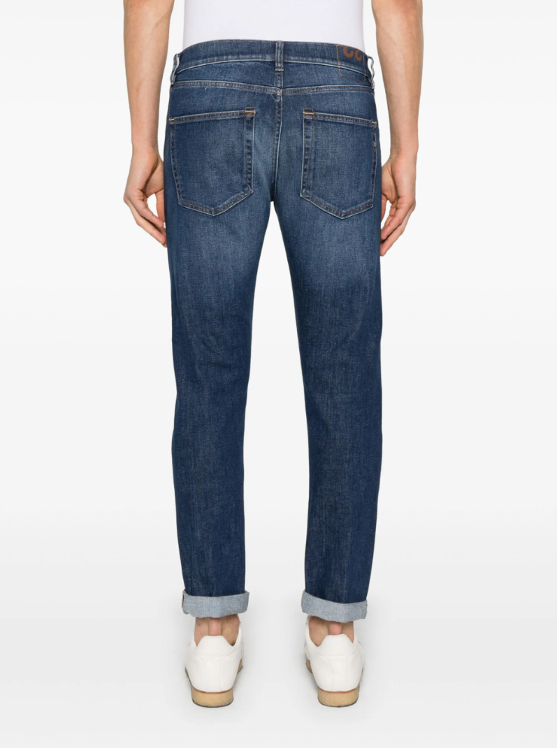 Dondup Icon jeans in indigo blue with button fly, five-pocket design, and logo patch.