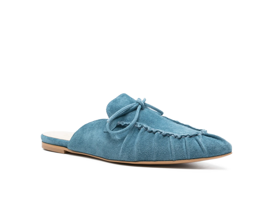 Blue suede tie-detail flat mules by Tela, made in Italy with slip-on design and pointed toe for chic everyday style.