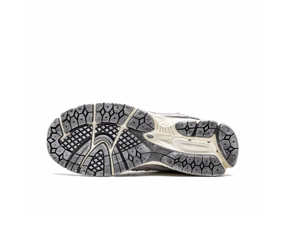 New Balance 2002R Protection Pack sneakers in Rain Cloud with distressed suede overlays and cushioned sole.