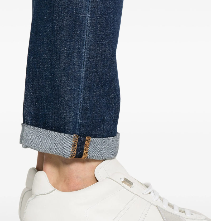 Dondup Icon jeans in indigo blue with button fly, five-pocket design, and logo patch.