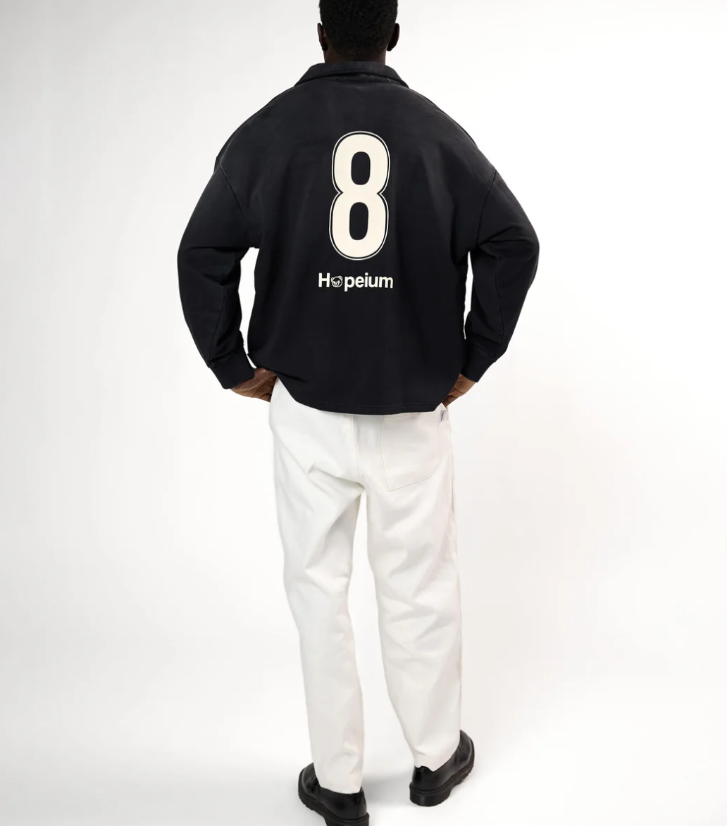 HOPEIUM Football Polo Sweat in washed black with front print, infinity back graphic, and oversized fit.