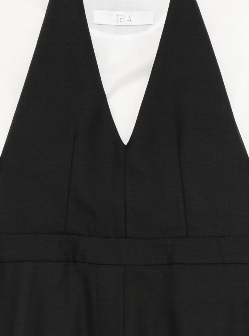 Black layered midi dress with white top by Tela, made in Italy with V-neck, cut-out detail, and asymmetric hem for standout style.