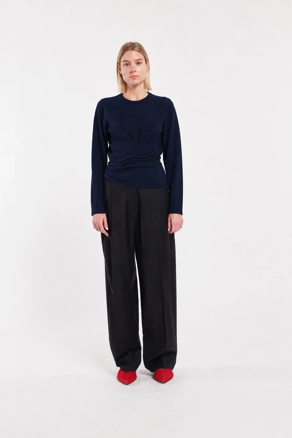 TELA Crossover Knit Top in Blue, crafted from soft carded wool with a wrap-effect front, draped waist and adjustable back tie.