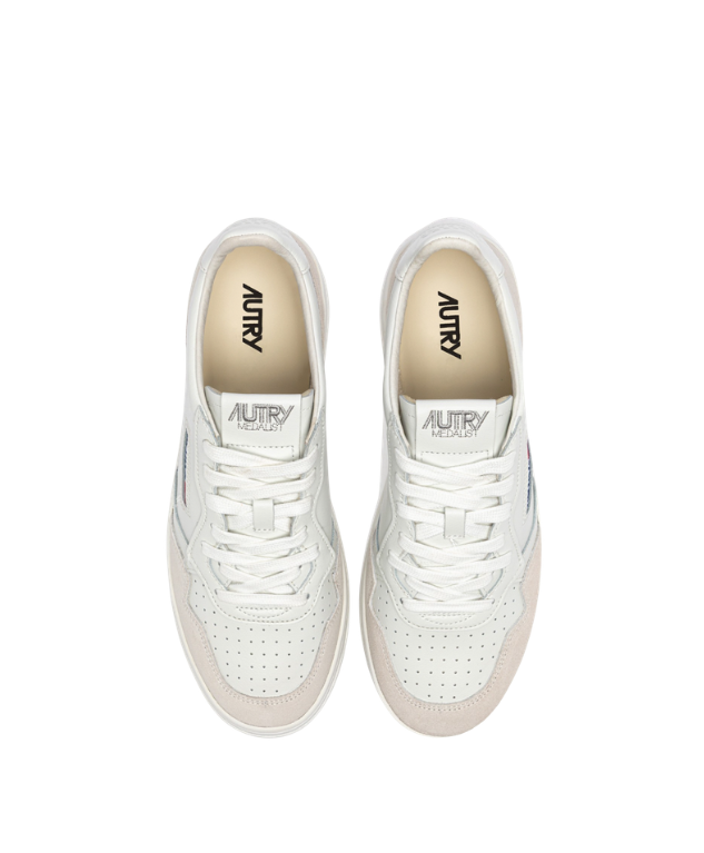 Autry Medalist sneakers in white with suede overlays, perforated toe, and rubber sole.