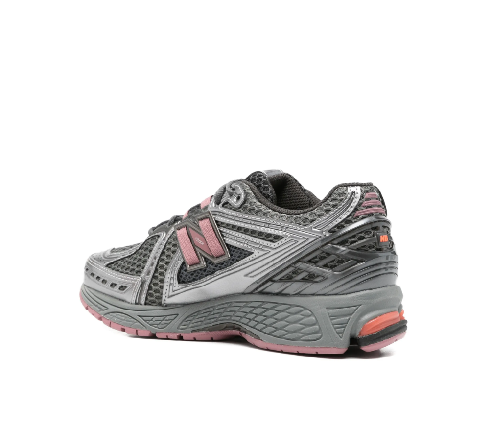 New Balance 1906R sneakers in rosewood with mesh panels, logo patch, and chunky sole.