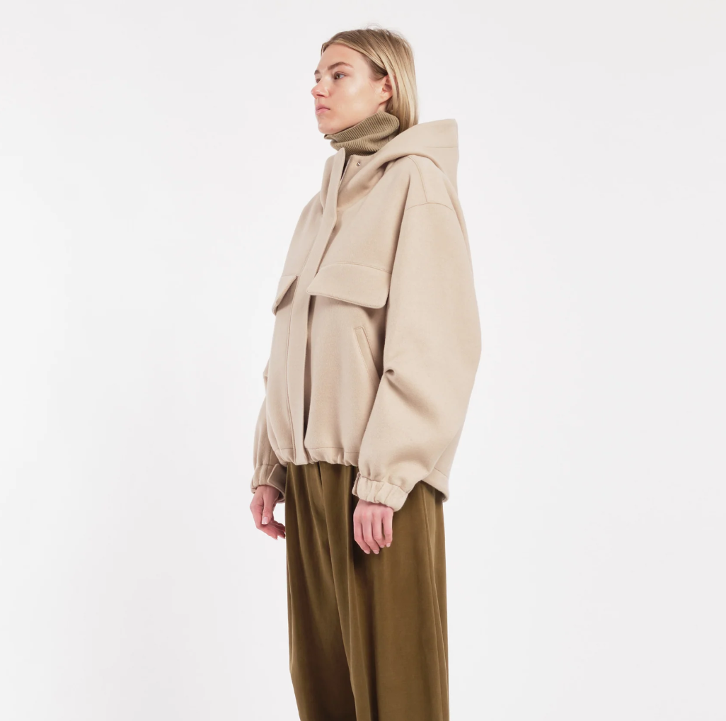 TELA Oversized Hooded Jacket in Beige, made in Italy from a virgin wool blend with flap pockets, zip-and-snap closure and adjustable hem.