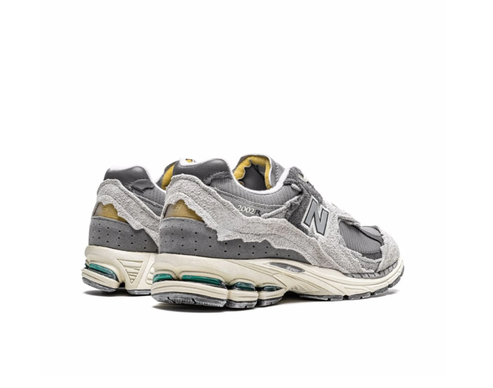 New Balance 2002R Protection Pack sneakers in Rain Cloud with distressed suede overlays and cushioned sole.