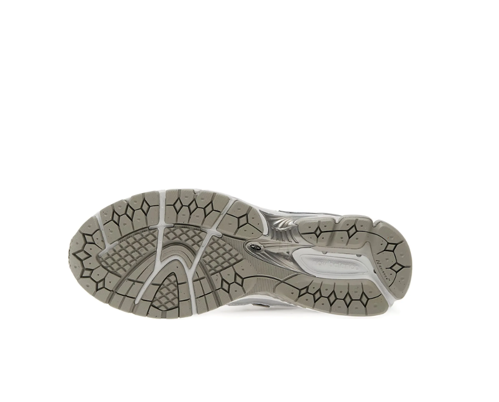 New Balance 1906R sneakers for men in grey and silver with mesh upper and cushioned sole.