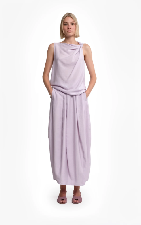 Tela asymmetric top in lilac with twisted shoulder detail, draped silhouette, and linen-viscose fabric.
