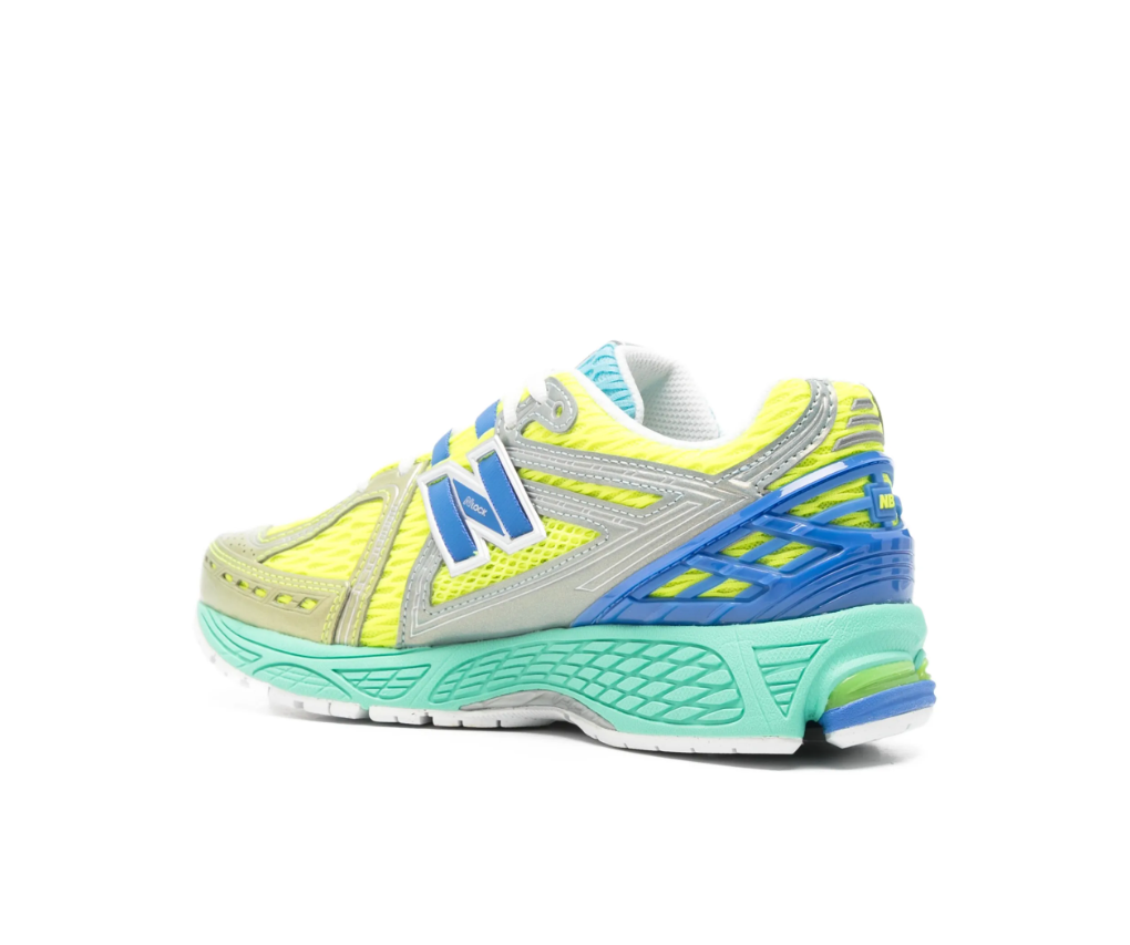 New Balance 1906R sneakers for women in yellow multicolour with mesh upper and metallic panels.