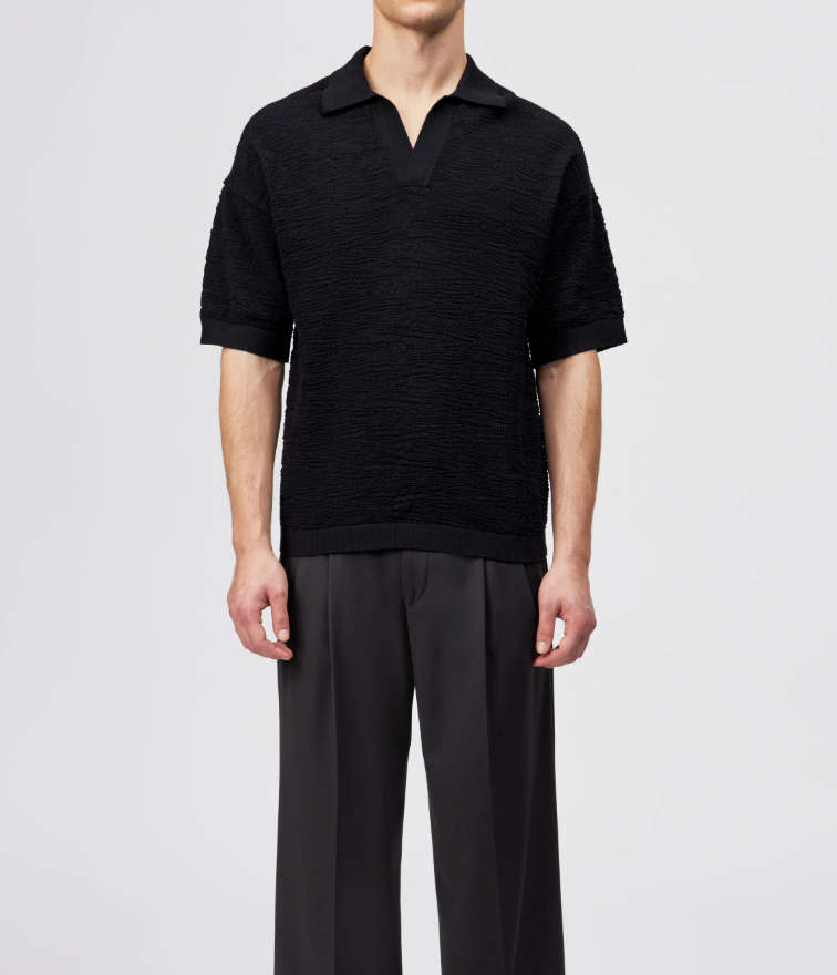 Black Drykorn LAURENZZO oversized cotton knit polo for men with short sleeves, wide placket, and soft textured knit for modern casual style.