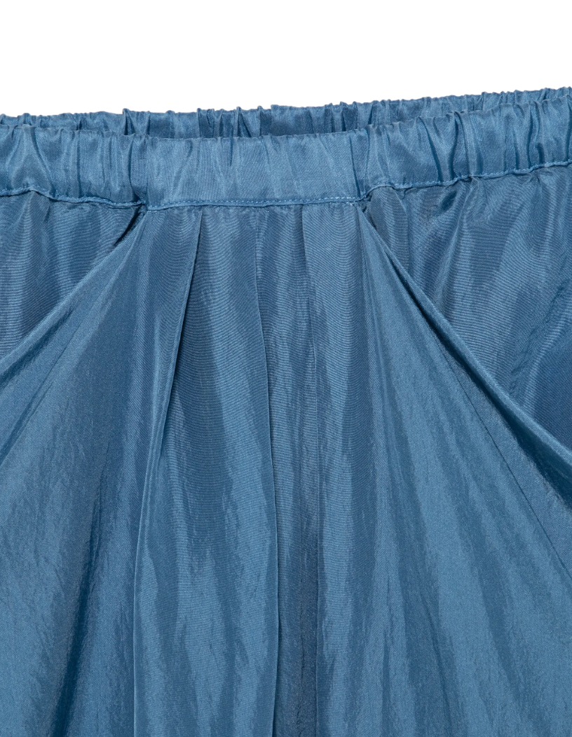 Tela Utopia draped midi skirt in blue silk with elastic waistband, gathered details, and pockets.
