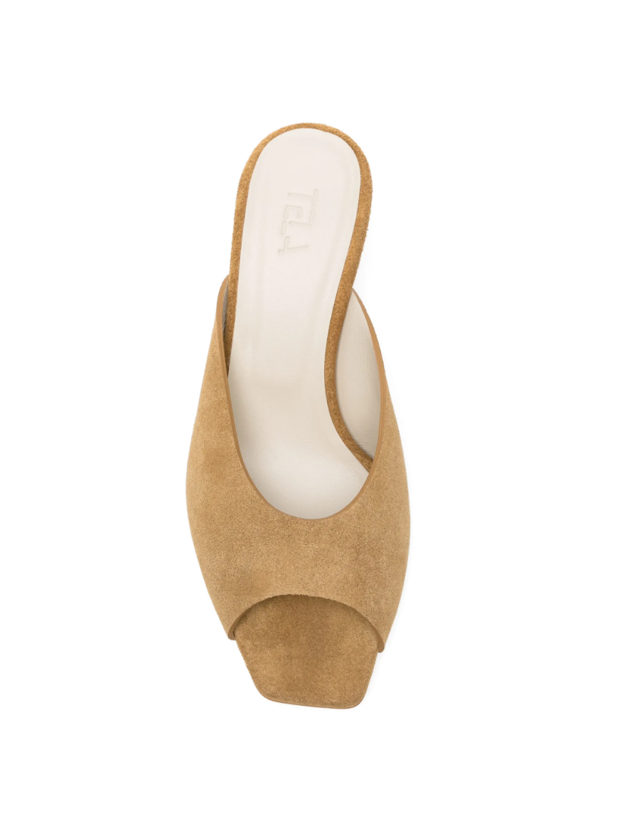 Mustard square-toe slippers by Tela in suede, made in Italy with peep-toe design and curved heel for chic modern style.