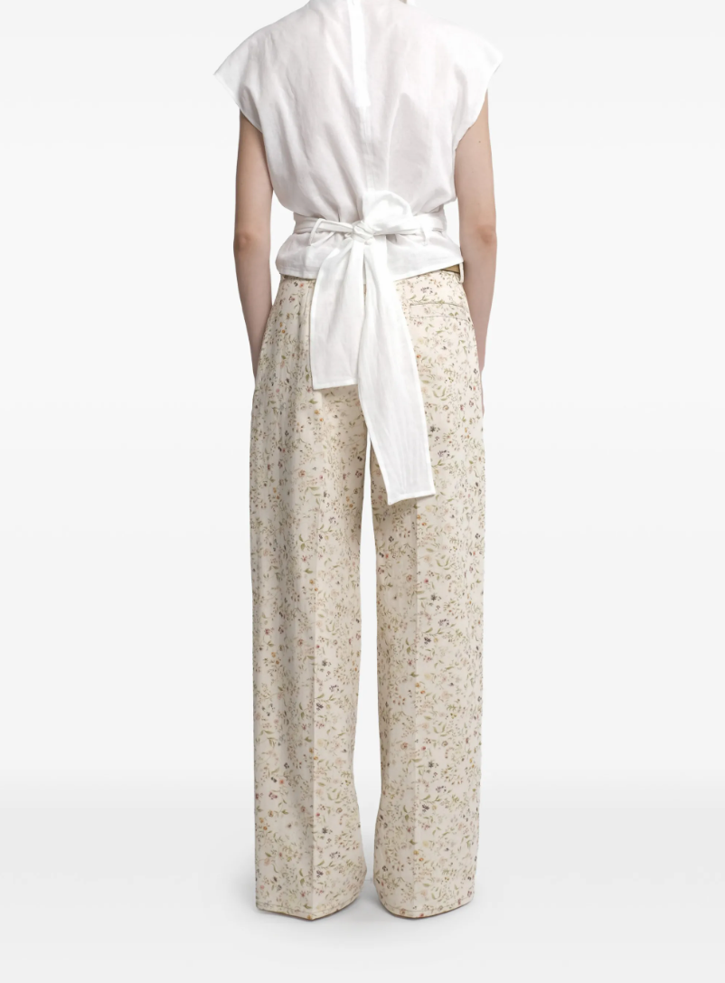 Tela floral print trousers in cream with wide leg, belt, and concealed closure.