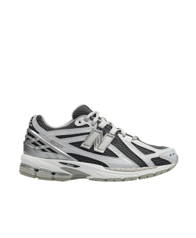 New Balance 1906R sneakers for men in grey and silver with mesh upper and cushioned sole.