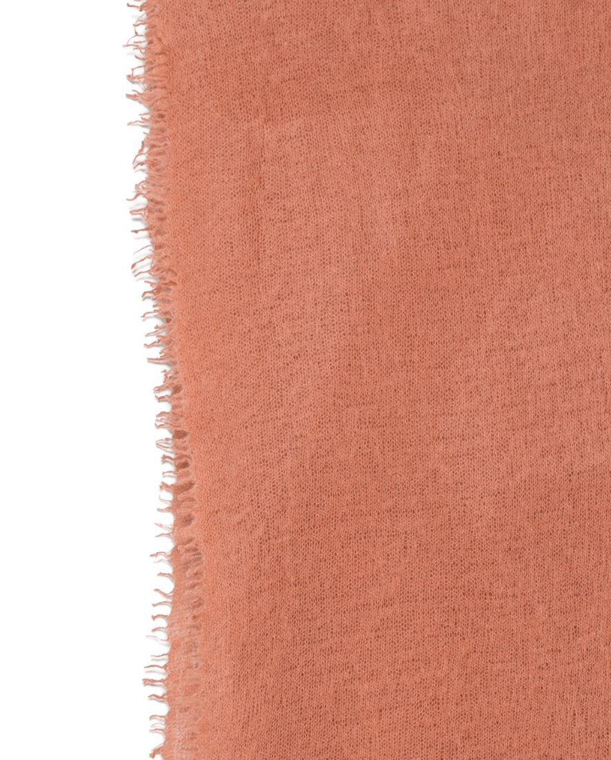 WARM-ME Small NOMAD Scarf in Terracotta, crafted from 100% cashmere with a lightweight fine-knit texture and fringed edges.