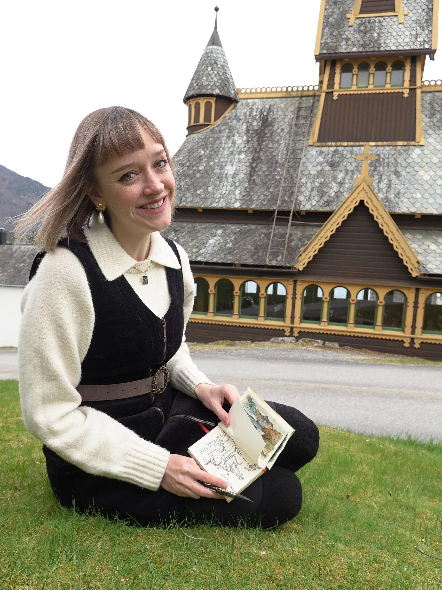 Visual folklorist Faina Lorah in the field researching Nordic traditions at Saint Olaf's Church in Norway.