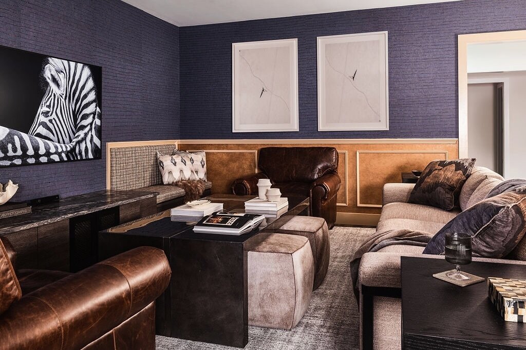 This basement was designed not just for leisure but for creating unforgettable family memories.

It offers versatile seating options with movable ottomans and cozy built-in benches, ideal for gaming marathons or movie nights that flow into the early 