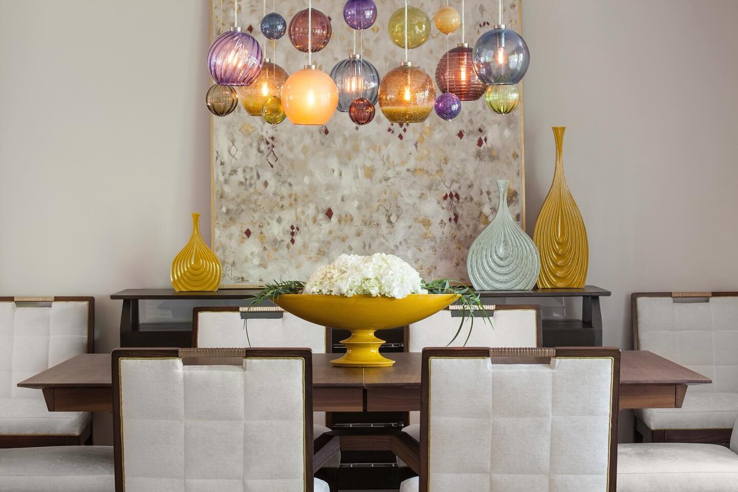 This striking dining room effortlessly combines our client&rsquo;s request for a tranquil atmosphere with a joyful color palette.

The captivating allure of a custom-made, multicolor glass-blown chandelier by @tracygloverstudio illuminates the space 