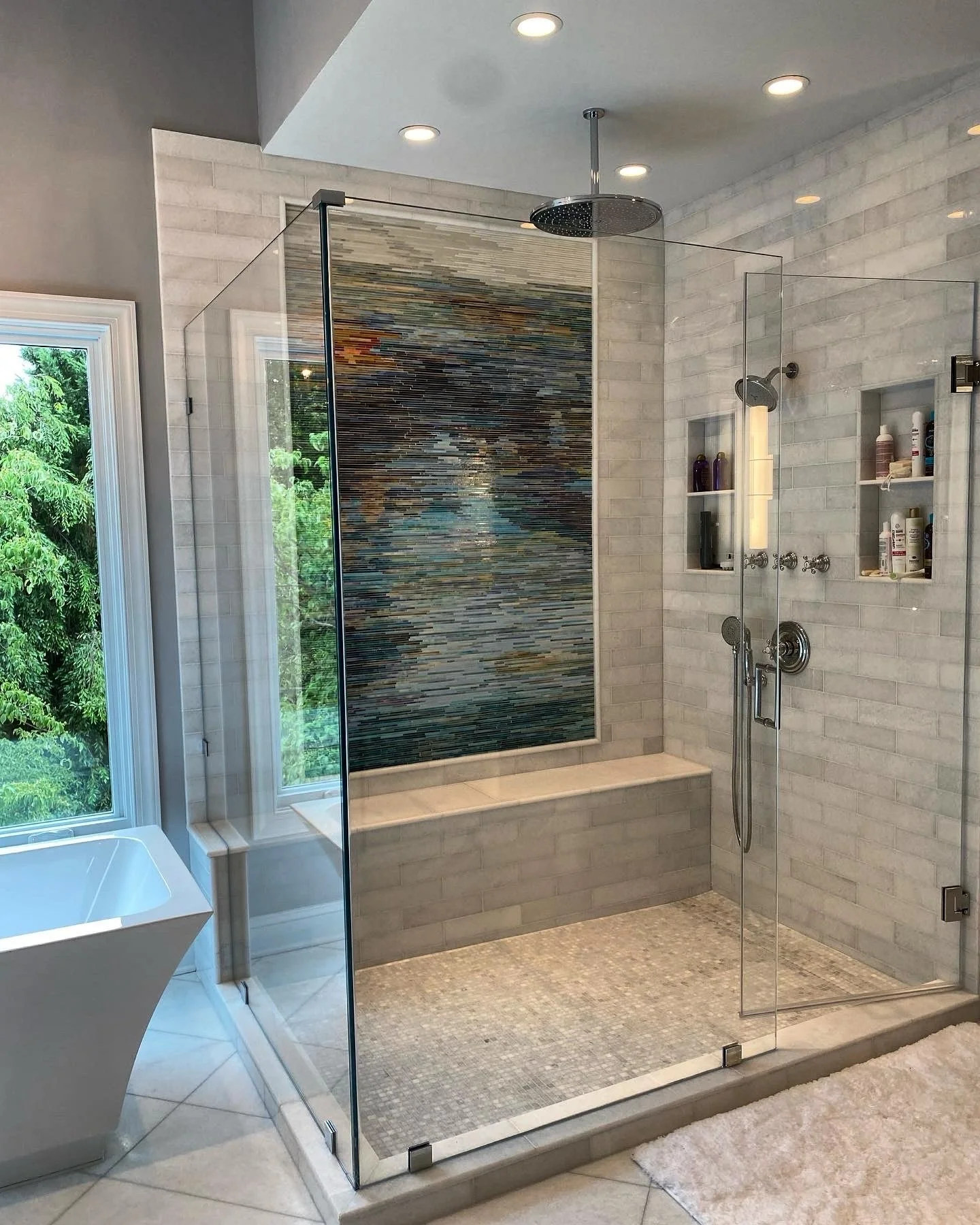 All the function, all the luxury, all in one space &ndash; frameless lines, a sleek soaking tub, artistic tile pairings, layered shower heads, and niches that keep it clean. 

But the true showstopper is the dramatic feature wall that turns the showe