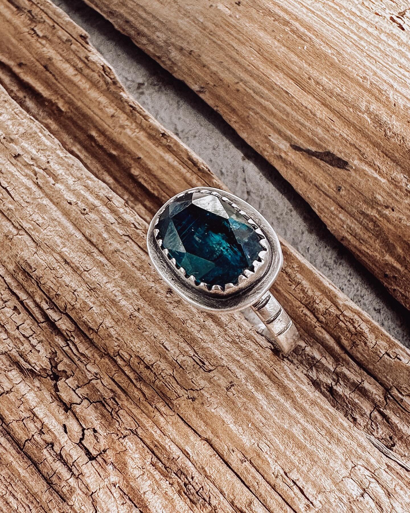 I&rsquo;ve been hoarding these gorgeous teal kyanites until I found the perfect setting. Loving the way it catches the light in this ring and the stone goes from dark to light ✨ 
.
.
.
#tealkyanitejewellery #kyanitejewelry #daintyjewelry #silversmith