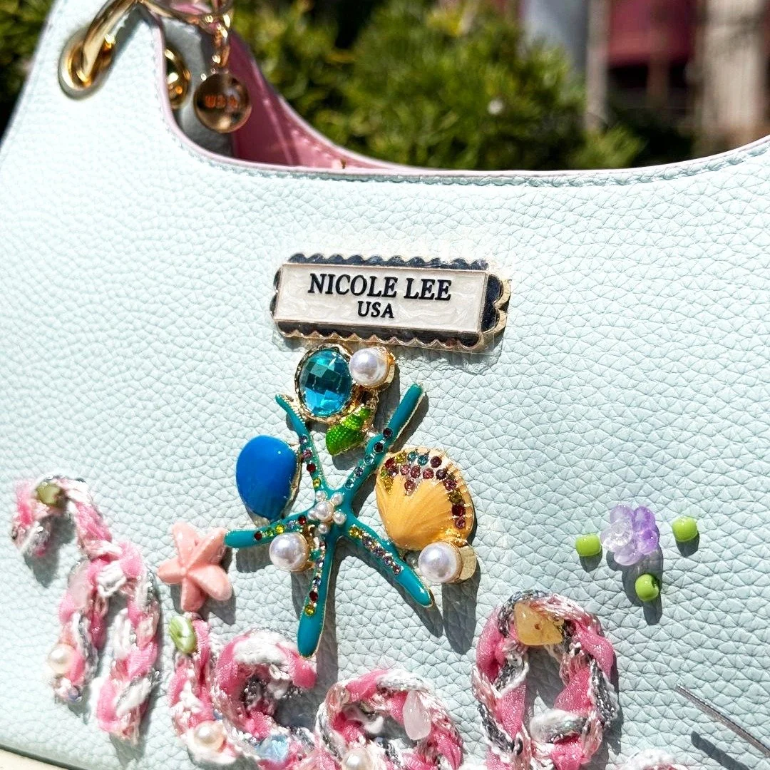 Not just a bag, your daily escape to the coast. Designed for versatility, the Nicole Ocean Collection blends bold detail with effortless elegance in every step. 🌊🪸

New Nicole Ocean Collection available now in link in bio.

#nicoleleeusa #handbag #