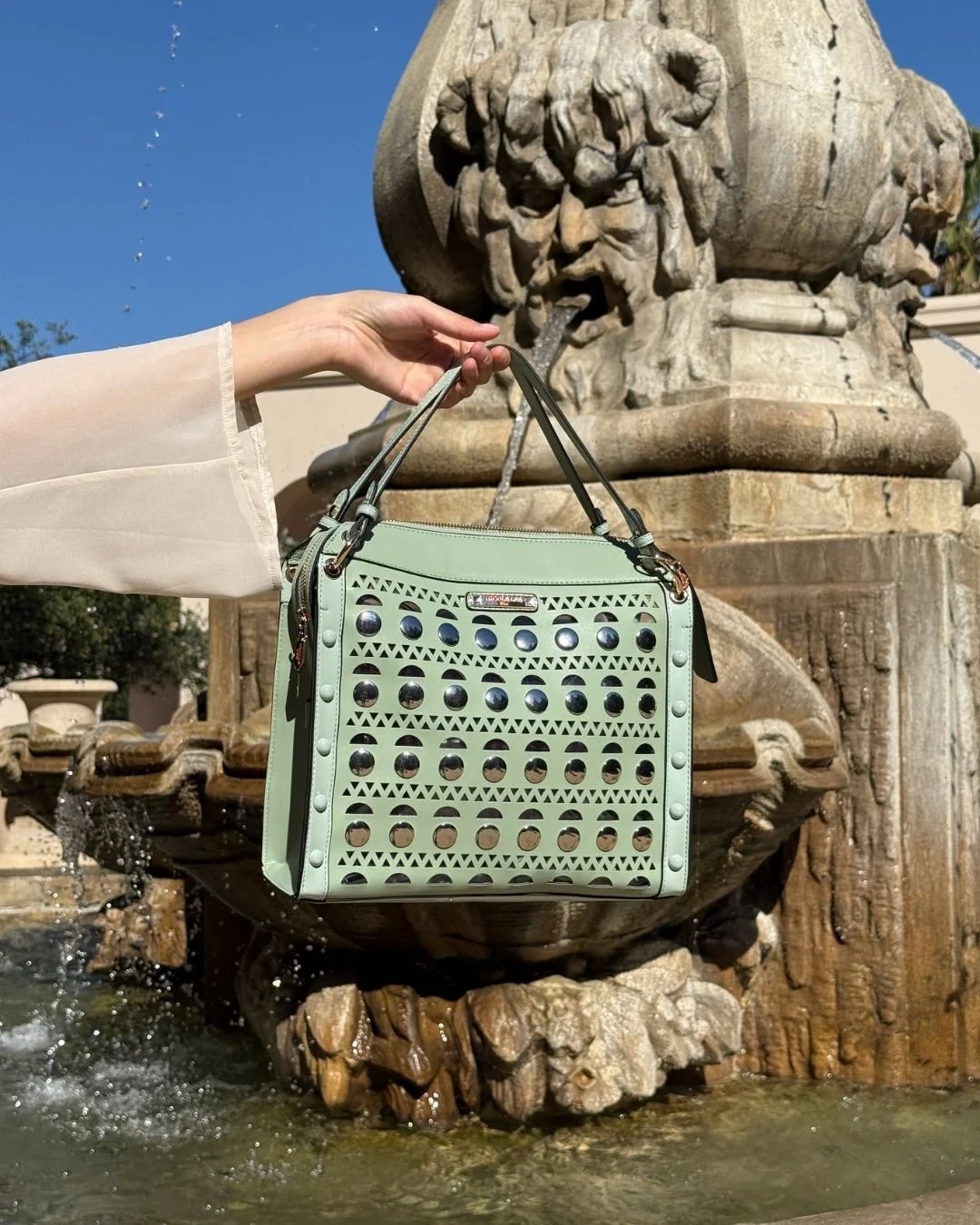 The Silver Pop Stud Satchel Bag redefines modern elegance with its structured silhouette, intricate geometric perforations, and bold gold stud accents, crafted to make a statement.

Silver Pop Stud Satchel Bag available now in link in bio!

#nicolele