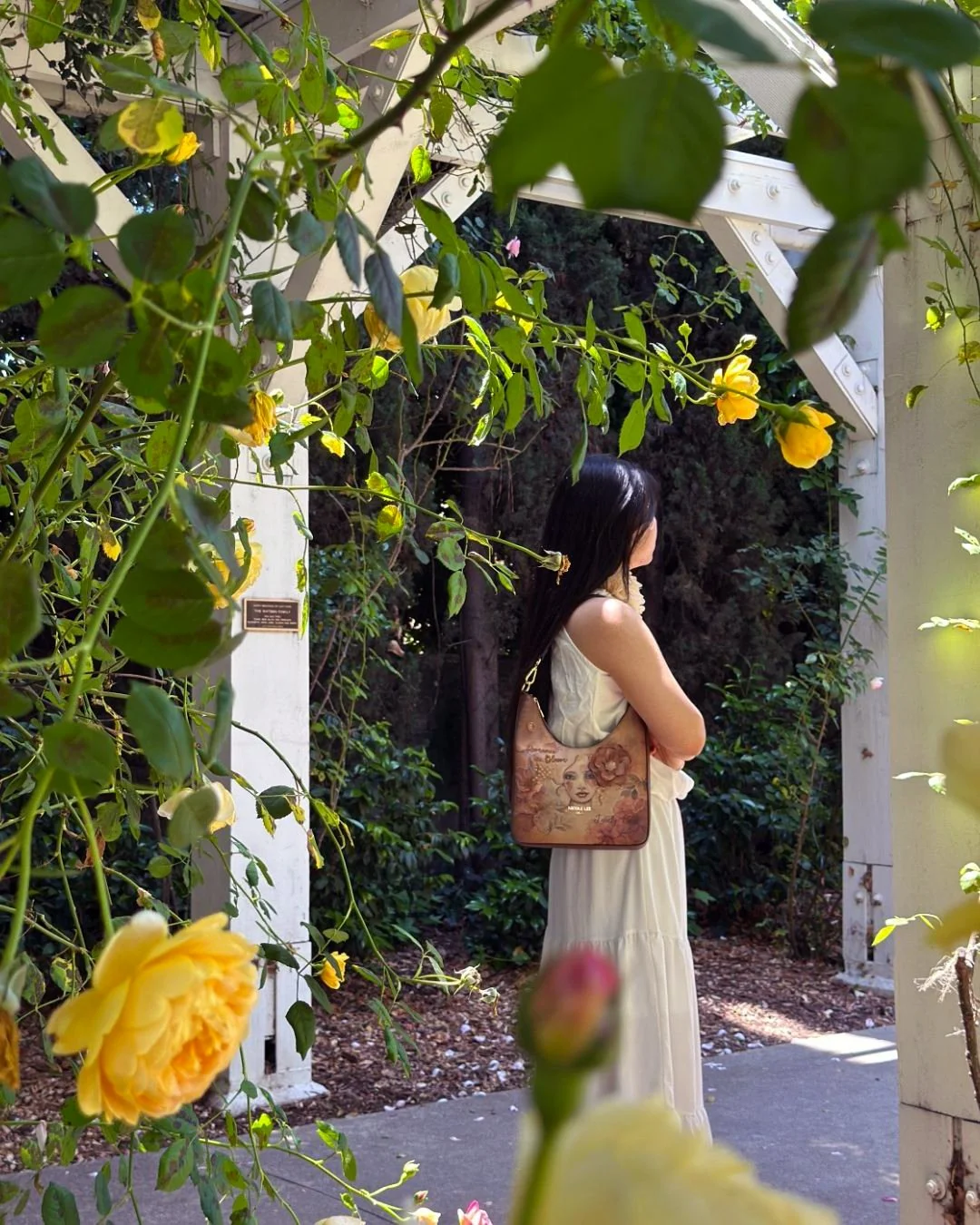 The Reflection OF Love Shoulder Bag enriched with delicate floral details and a feminine portrait that captures a sense of romance and artistry. Comfortable shoulder strap, this piece blends everyday functionality with elevated style.

Find the Refle