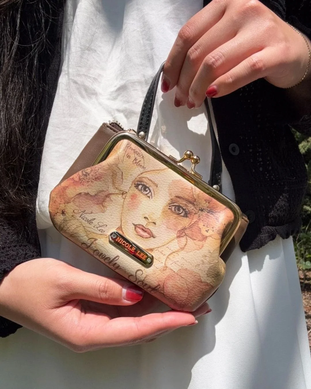 This Mini Frame Top-Handle purse comes with a compact, structured mini purse with a classic frame closure, and elegant top handle. Designed with a secure clasp opening and organized interior, it&rsquo;s perfect for carrying small essentials while add