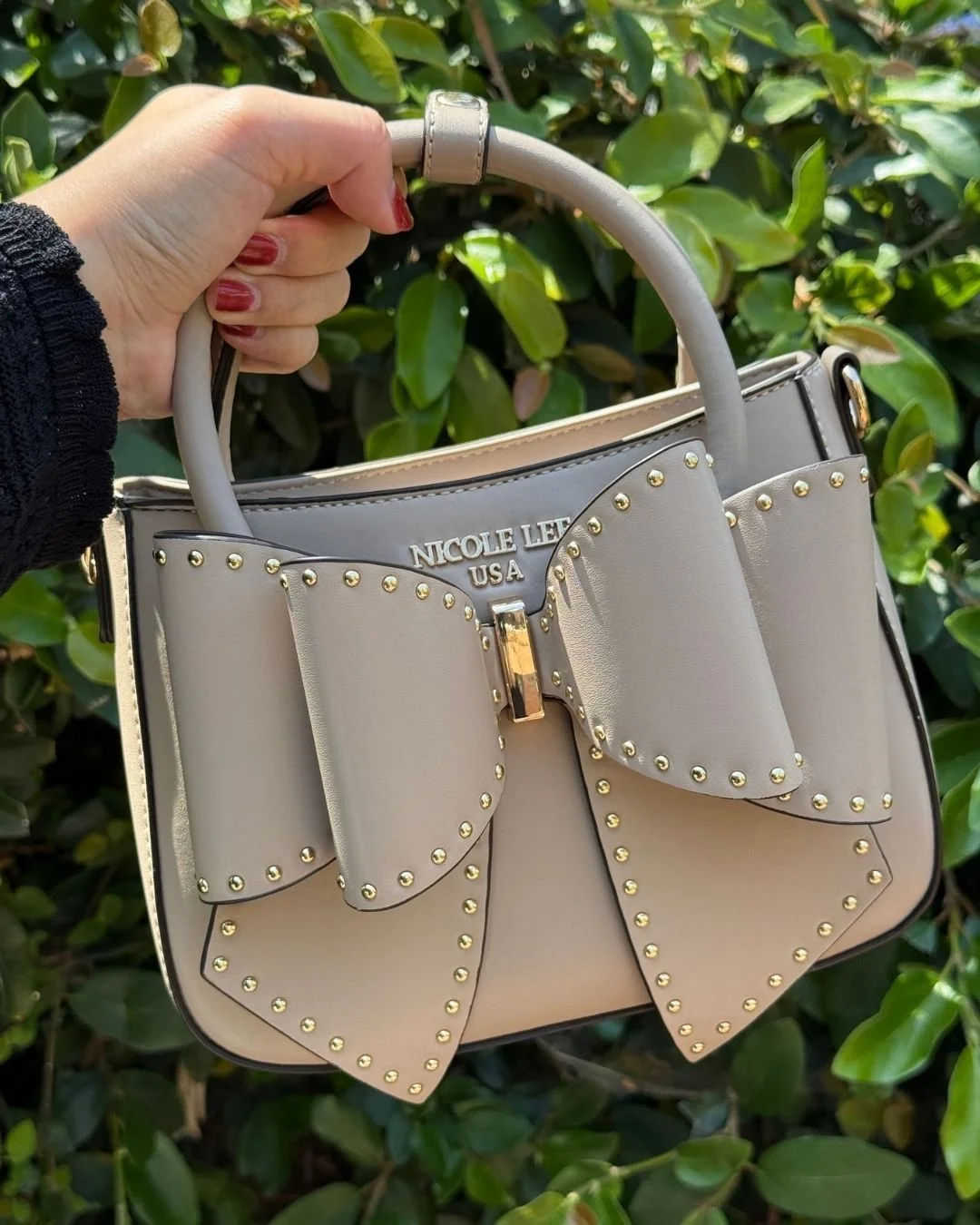 The Studded Bow Handbag blends edgy and feminine style, a 3D bow detail enhanced with polished stud accents for an eye-catching touch. 🎀🩷

Studded Bow Handbag available now in link in bio!

#nicoleleeusa #handbag #accessories #ribbonbows #outfitins