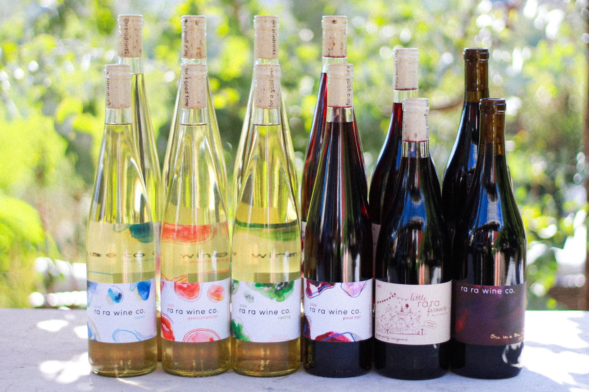 12 wine bottles in an outdoor setting.