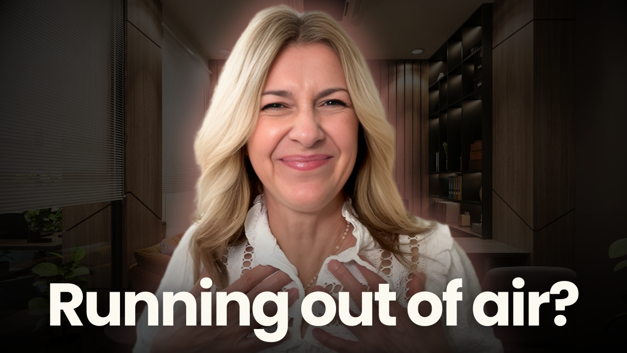 Woman showing strained expression with hands on chest, illustrating running out of breath when speaking and difficulty maintaining steady voice during conversation.