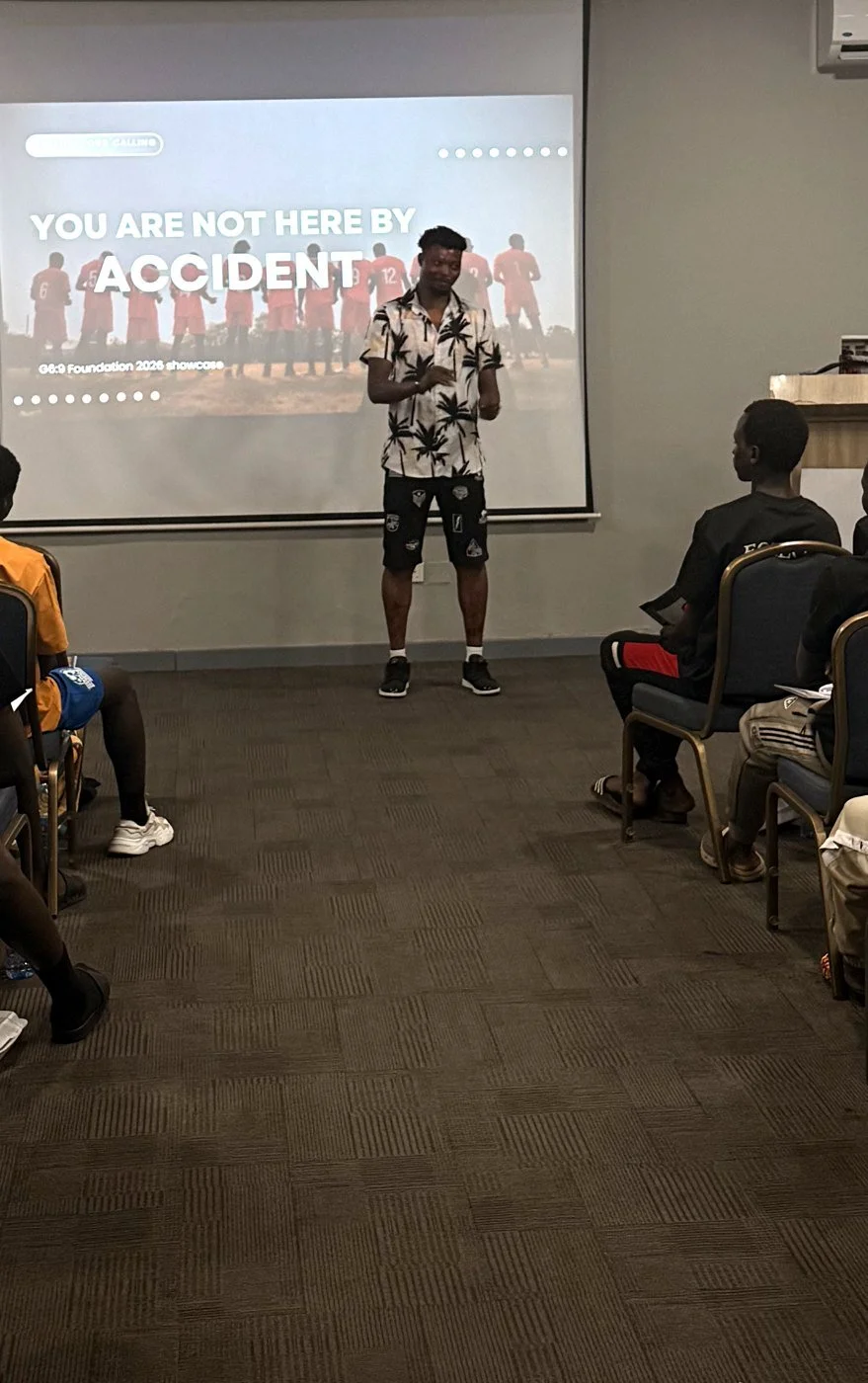 Moses Mensah, a G6:9 Foundation alumnus, speaking to young players