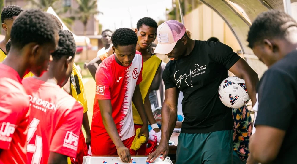 A coach and players working through tactics on a board
