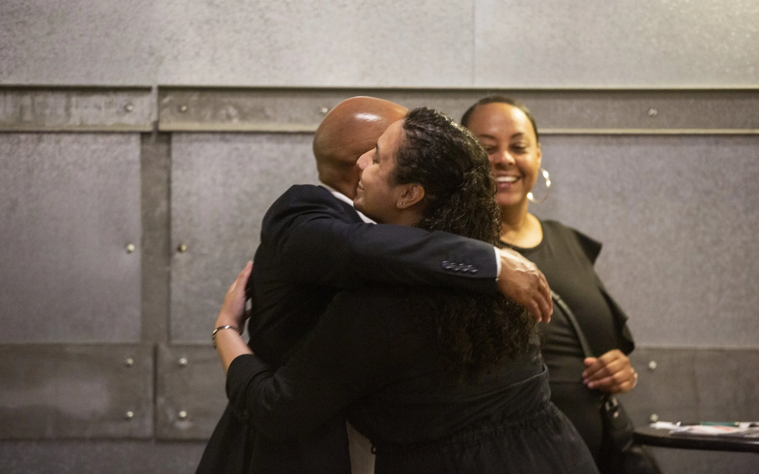 Family members Gerald and Jenna  hugging.