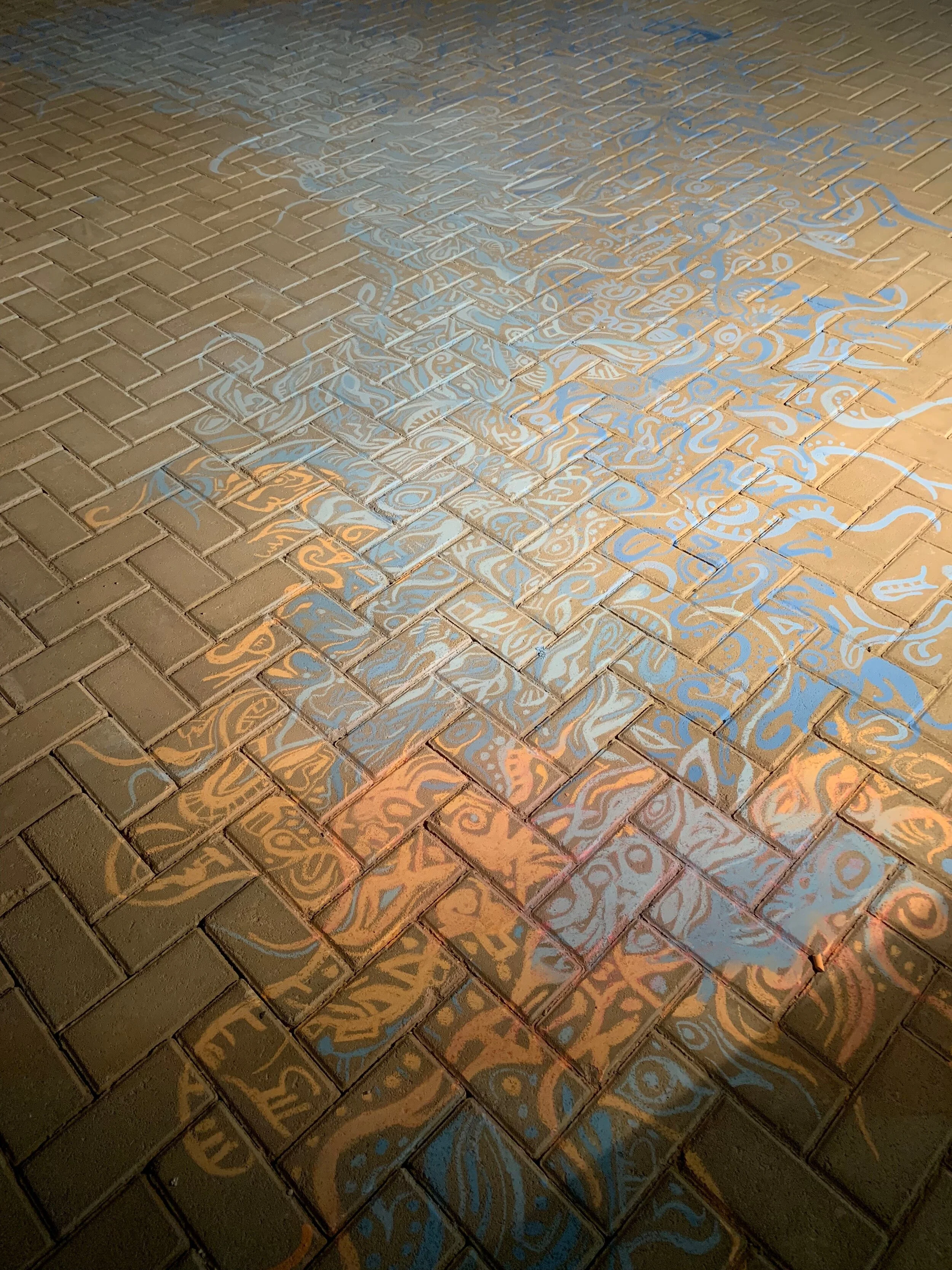 chalk drawing in an incommunicable "language" of forms, for "Imperfect Isometry," 2019, videos of border walls  (Jerusalem/Palestine, US/Mexico) and prison wall, vintage sari tapestry, chalk drawing, spinning found Kalba merrygoround, dimensions vari