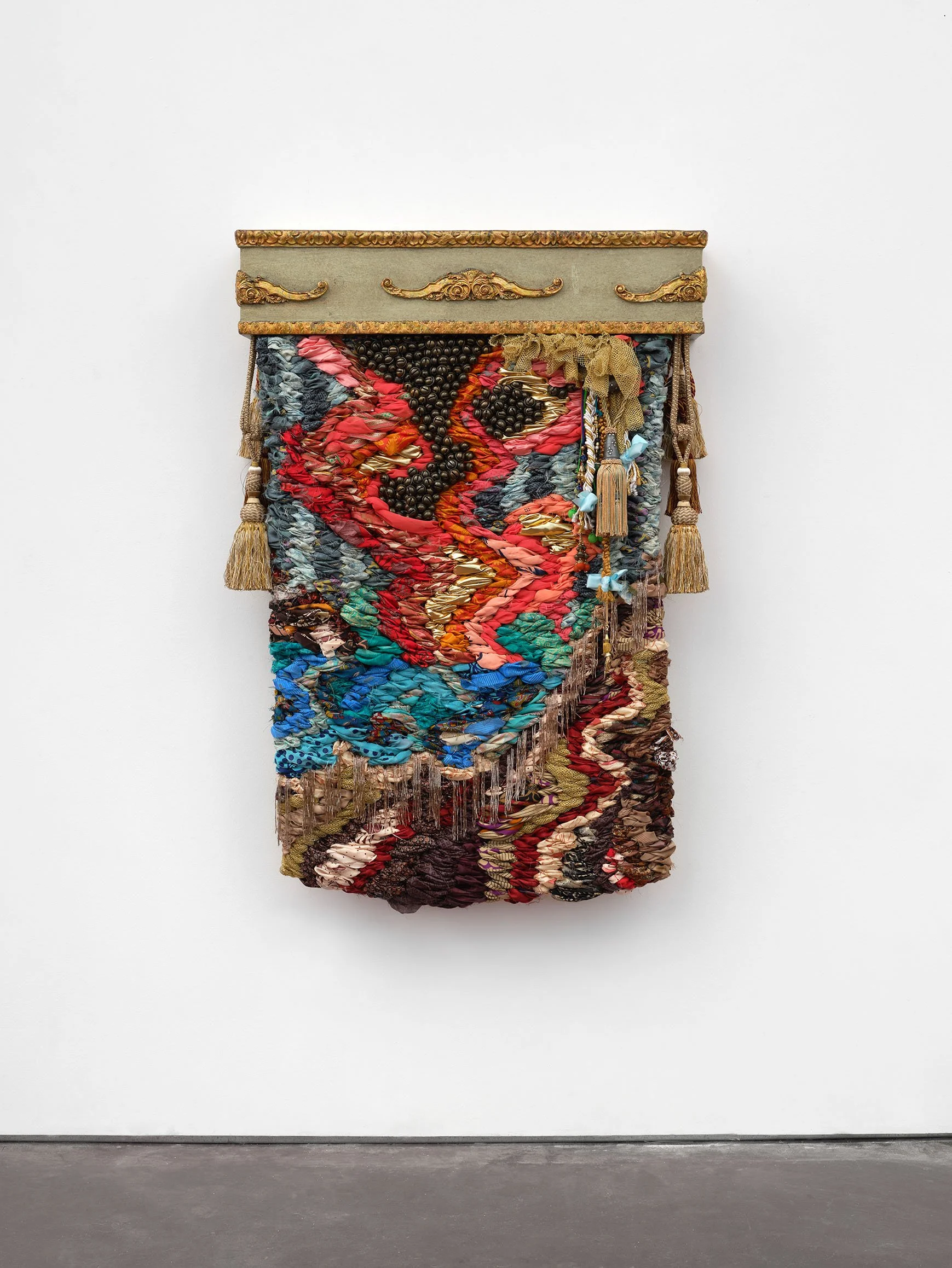 magic mountain, 2024, worn saris, fabric, tassels, beaded trim, and vintage curtain box