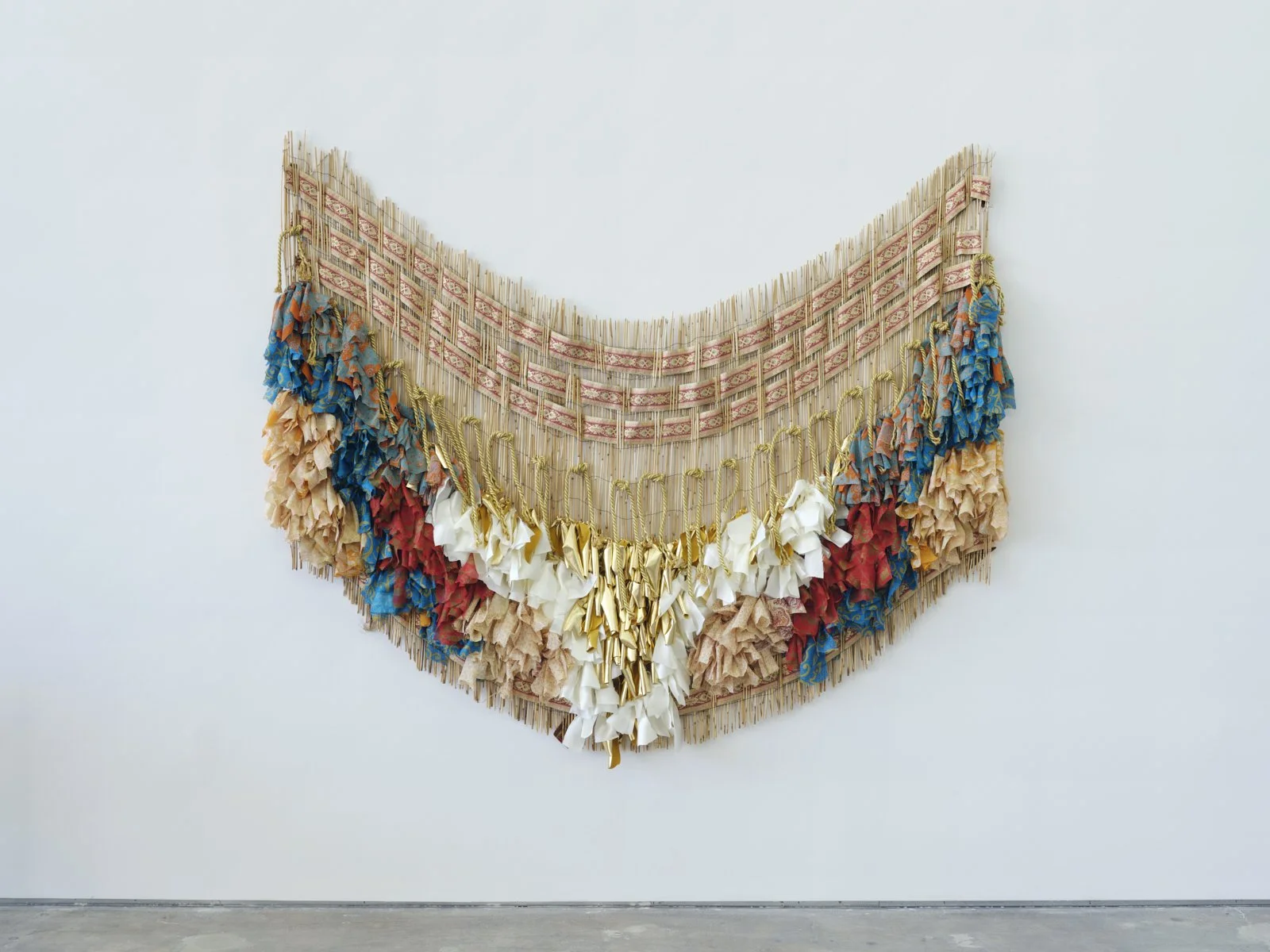 memory falls (Kaieteur Falls), 2022, vintage saris, fabric, cord, and reed fence, 60" x 72"