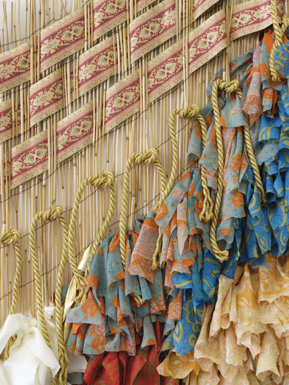 memory falls (Kaieteur Falls), 2022, vintage saris, fabric, cord, and reed fence, 60" x 72"