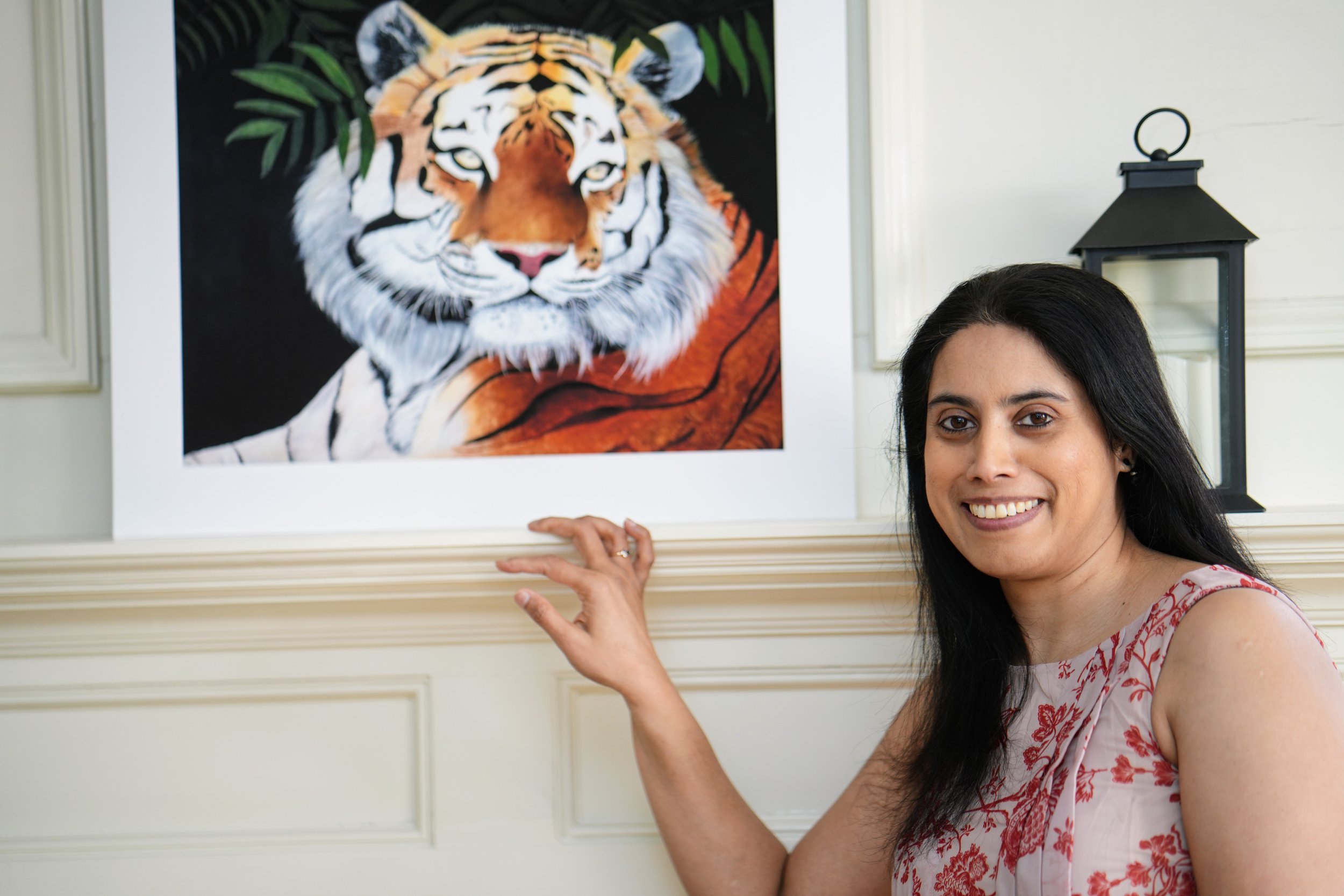 A tiger print of a painting on the wall. Wildlife art.
