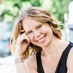 Smiling woman with long hair in outdoor setting