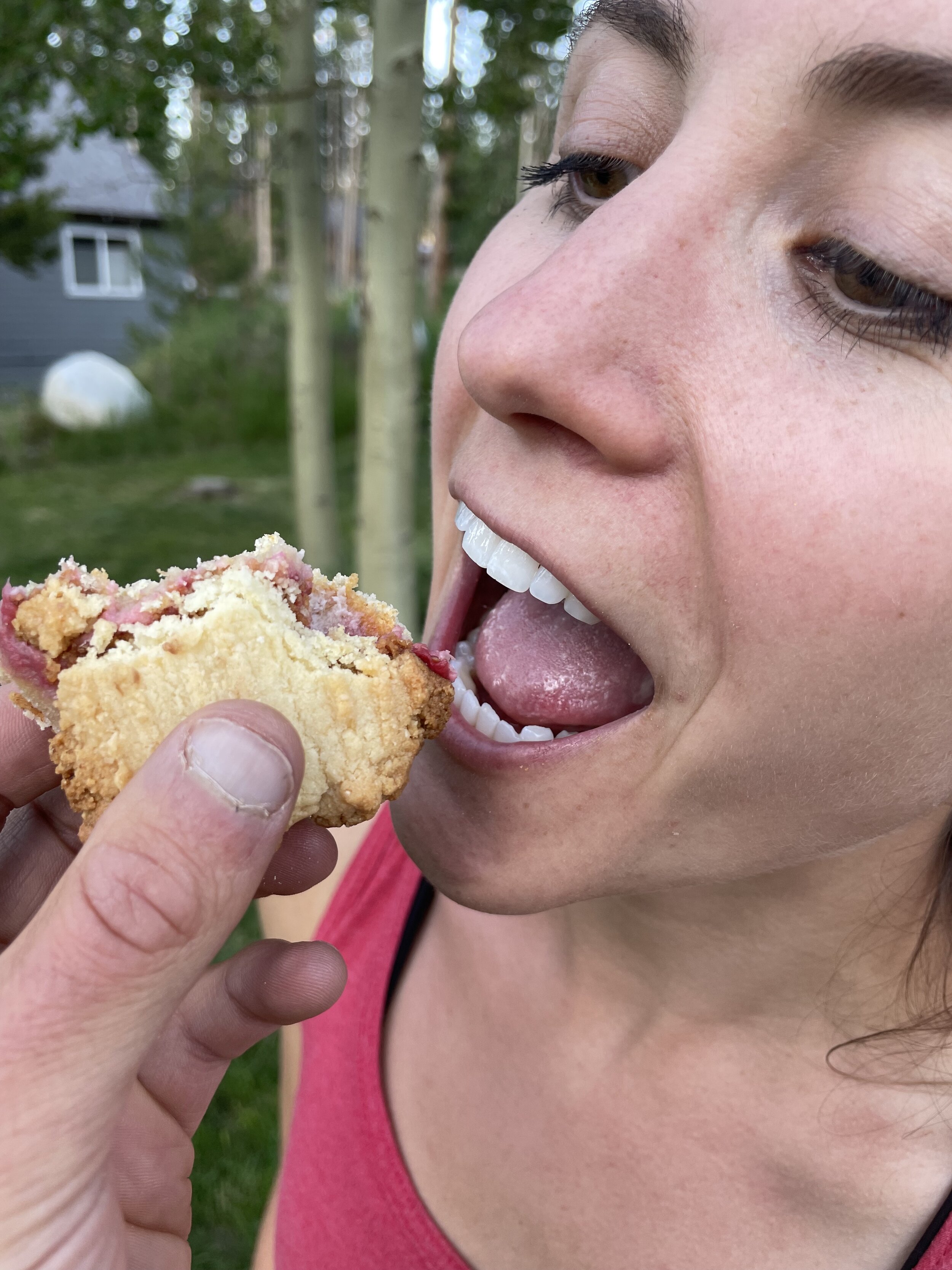 Haley opening her mouth for a bite of cookie dough sandwich