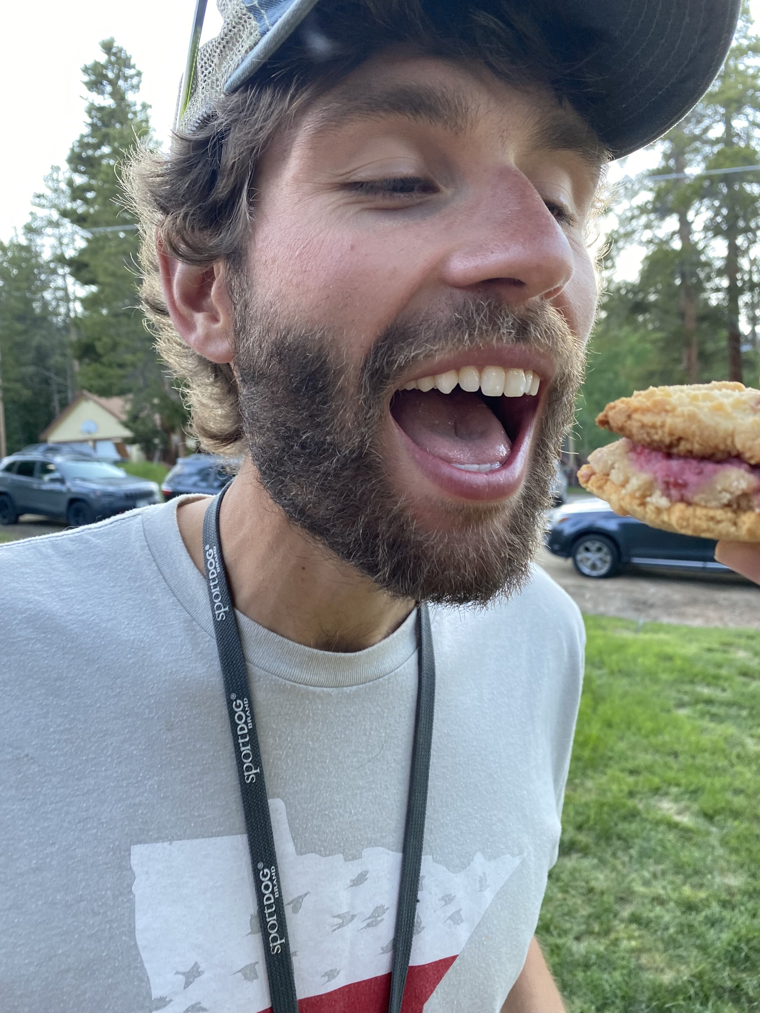 Tyler opening mouth for a bite of cookie dough sandwich